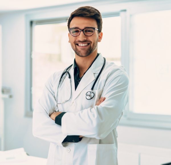 Portrait,Of,Handsome,Male,Doctor,With,Stethoscope,Over,Neck,Working