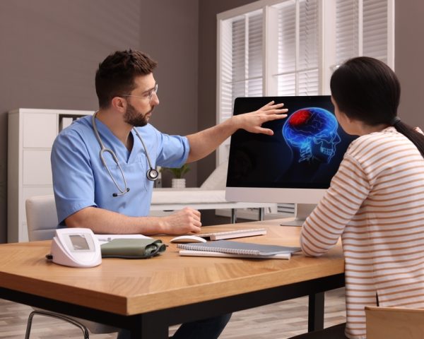 Neurologist,Showing,Brain,Scan,To,Young,Woman,In,Clinic